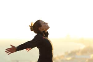 Woman getting a deep breath of fresh air after a run.