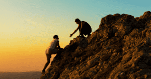 Personal motivating friend to finish climbing to top of mountain